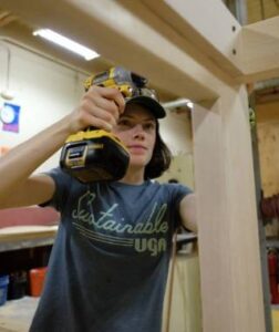 A UGA Office of Sustainability intern holds a drill.