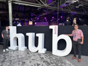 Two people stand in front of Berlin Hub letters.