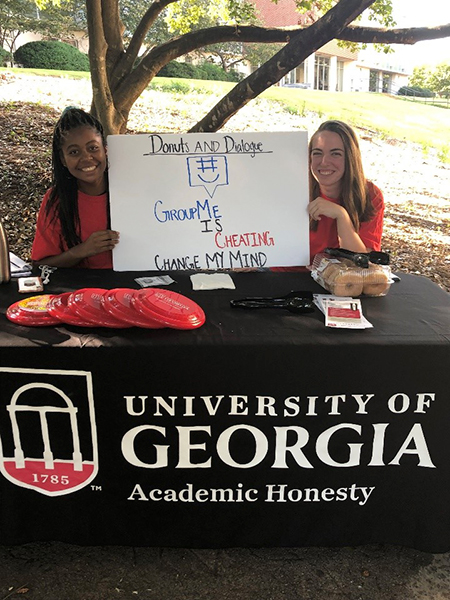 Students promoting Academic Honesty at tabling event outdoors