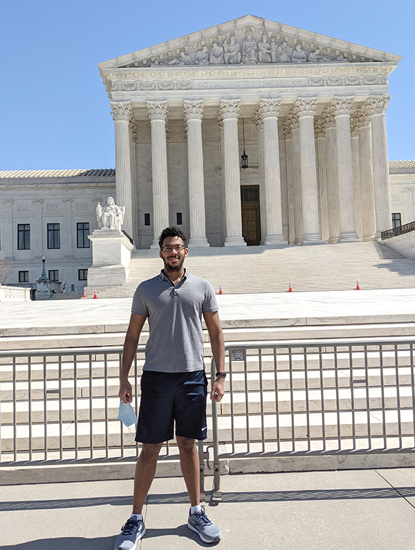 Ethan Knight-Scott standing in front of the United States Supreme Court Building