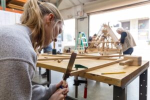 A student works at a wood table.