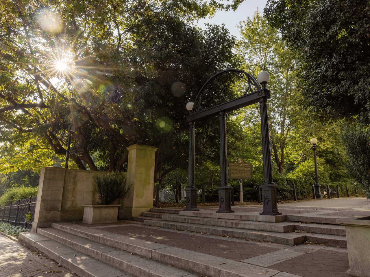 The Arch with early morning sunlight filtering through the trees on the North Campus Quadrangle.